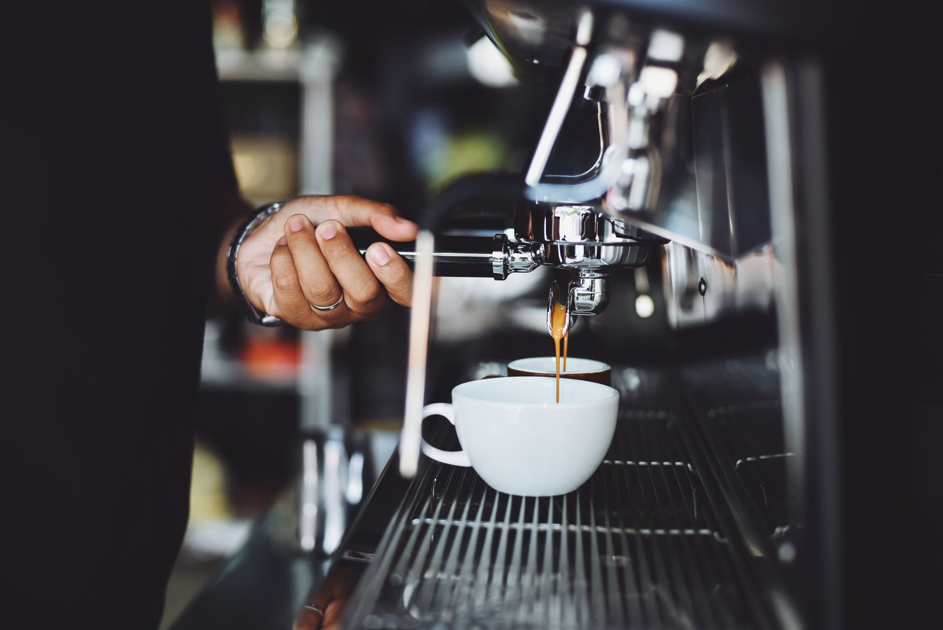 close up of hand holding coffee machine